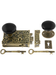 Solid Brass Century Rim Lock Set with Black Porcelain Knobs.